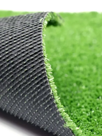 A view of the turf from the side, showing the dense blades attached to the flexible yet strong backing. This construction is what makes it so durable.