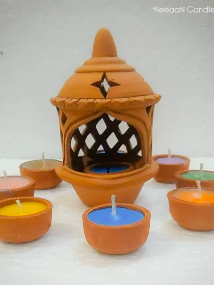 Add a touch of tradition with a pop of color. This handcrafted clay lantern comes with vibrant terracotta tealights.
