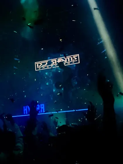 A moment of 'divine violence' at Hydra. The crowd's hands are up, confetti is falling, and my logo shines bright, capturing the beautiful chaos of a perfect night.