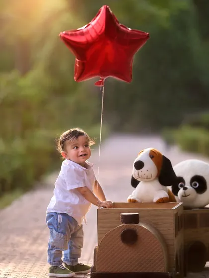 Taking his favorite stuffed animals for a ride. I encourage bringing personal toys to photoshoots to make them even more special, as seen in this adorable pre-birthday train-themed session.