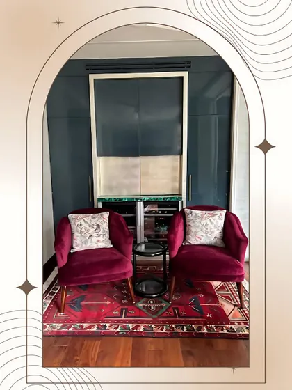 This cozy lounge bar, part of a luxury executive suite, is designed for private relaxation. I paired rich velvet armchairs with a deep blue accent wall and a classic Persian rug to create an intimate and sophisticated corner for unwinding.