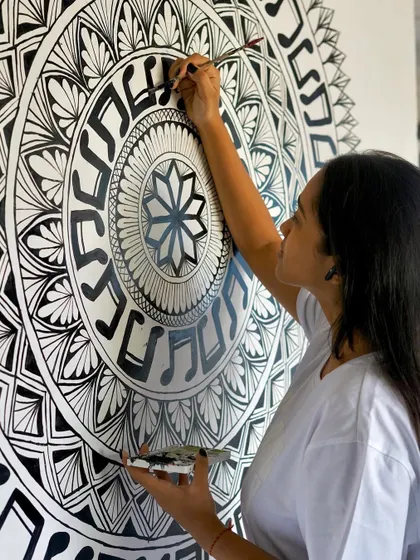 Another angle of the freehand music mural. You can see the focus and precision it takes to paint clean lines and intricate details on such a large scale.