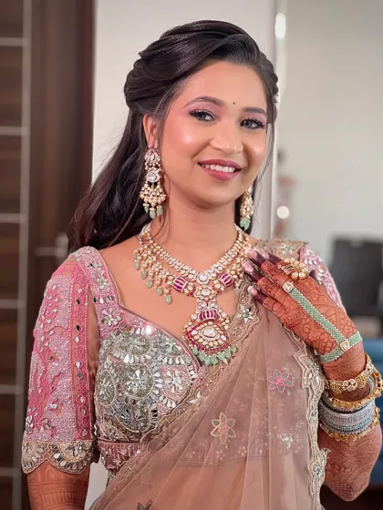 A close-up of the bride's happy face, her makeup perfectly complementing the pastel tones of her outfit.