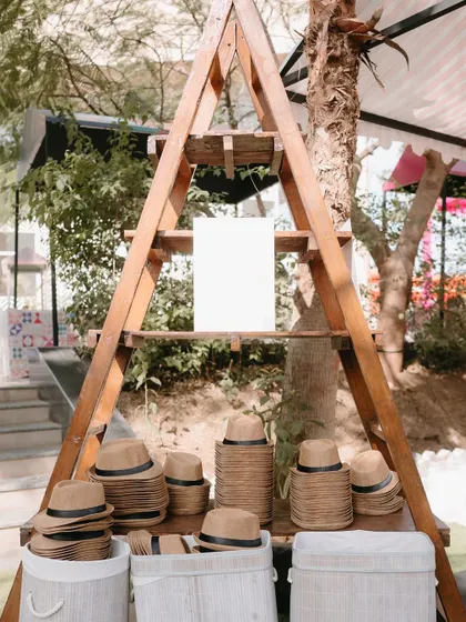 A hat station for a sunny outdoor event. A practical and stylish party favor that guests can use right away.