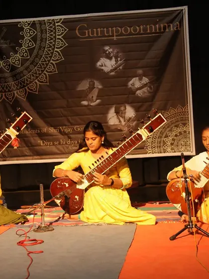Three of my students performing a sitar piece together on stage. Learning in a group setting helps build camaraderie and musical synchronization.