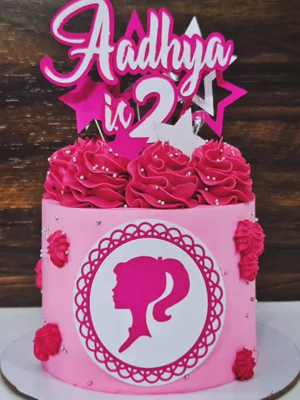 A pretty pink Barbie cake for Aadhya's 2nd birthday. This chocolate truffle cake features the classic Barbie silhouette and lots of pink swirls.