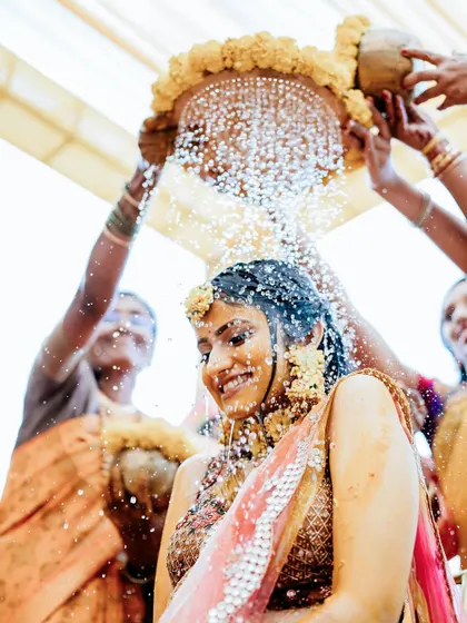 A bride enjoying the traditional holy bath during her Haldi, a moment of blessings and joy.