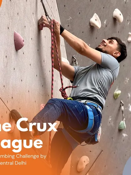 A male climber makes a powerful move during a lead climbing challenge. The Crux League features routes that demand both strength and strategy to conquer.