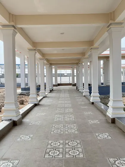 A completed walkway showing the finished flooring and columns, ready for devotees.