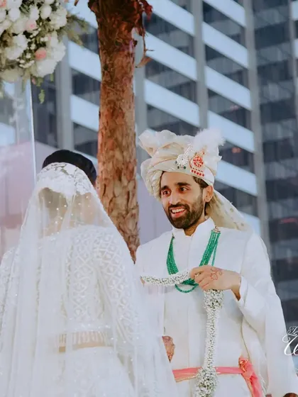 The groom's look of pure joy and anticipation as he sees his bride for the first time at the mandap.