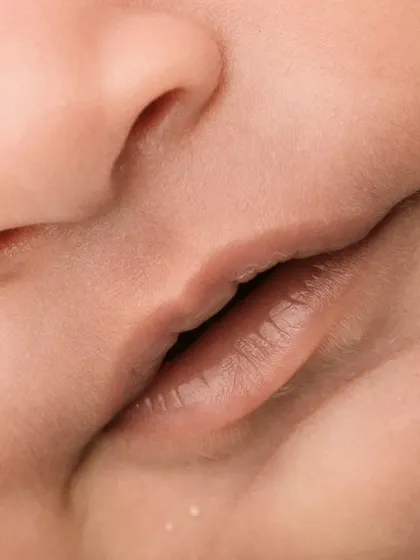A close-up of a baby's perfect little lips and nose. These macro shots are a beautiful way to appreciate their tiny features.