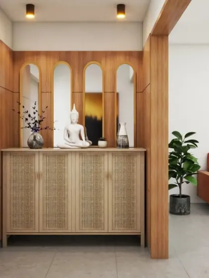 A beautiful rattan-front cabinet is framed by wooden paneling in this foyer. The arched mirrors above reflect light and add a sense of height and elegance to the entrance.