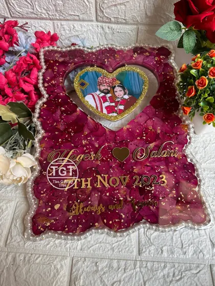 The rich color of the red rose petals contrasts beautifully with the white pearl border, creating a classic and timeless wedding keepsake.
