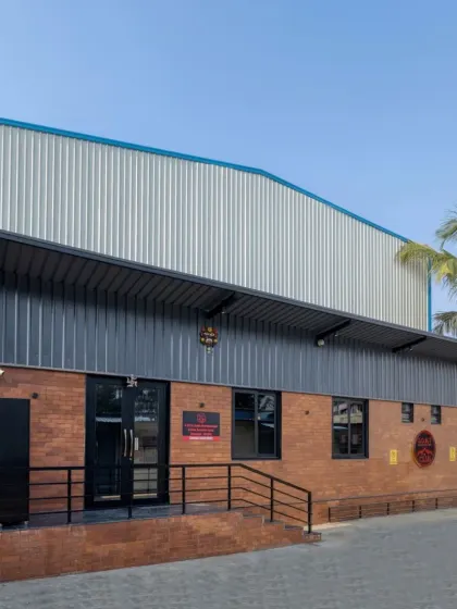 My design and build services extend beyond homes. For the GOAT Club in Bangalore, I designed a professional-grade badminton facility, combining an industrial pre-engineered building with warm exposed brick to create a functional and inviting community space.