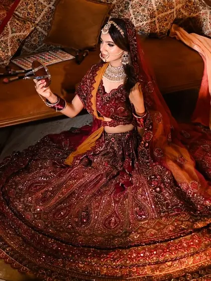 It's all about the attitude and the outfit. This wide shot showcases the full grandeur of a magnificent bridal lehenga, creating a portrait that is both powerful and regal.