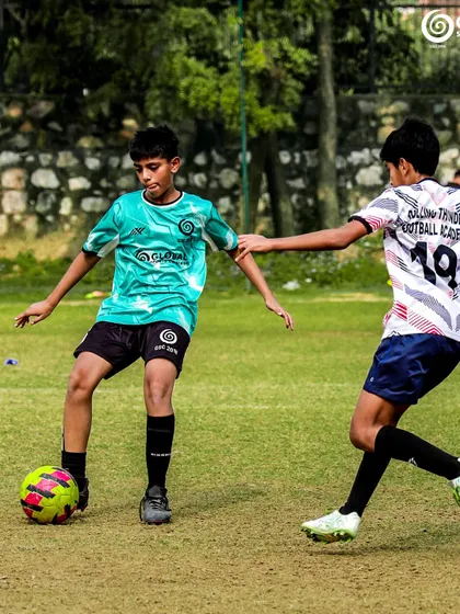 A tense moment as two players challenge for the ball, showing the competitive spirit of the league.