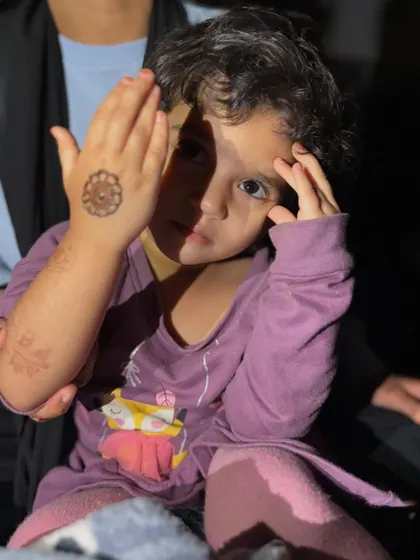 A simple mandala design is perfect for kids. Here, my niece is playfully showing off the small, circular pattern on the back of her hand. It's a quick, elegant, and fun option for any occasion.