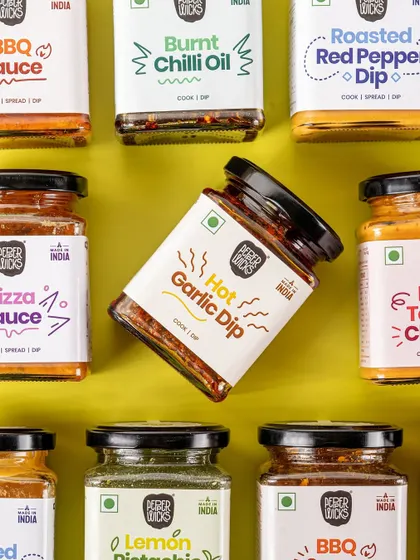 A creative grid layout of various dips for Pepper Wicks. This type of shot is perfect for showcasing a wide product range in a single, visually engaging image for a brand's social media feed.