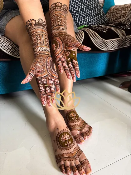 A complete bridal look with intricate mehendi on the hands and simpler, elegant lotus designs on the feet.