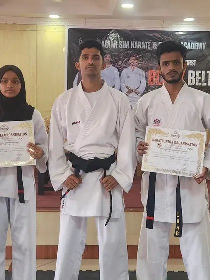 A proud moment for our first black belts. They stand with their certificates, marking the culmination of years of dedicated training.