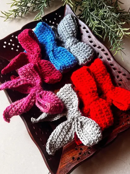 A collection of bow hair clips in a wooden tray. They make such a cute and colorful display.