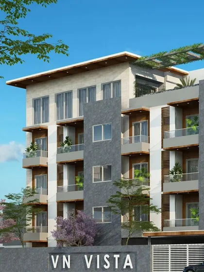 A closer view of the VN Vista facade, showing the layering of materials and the integration of greenery on the rooftop and balconies.