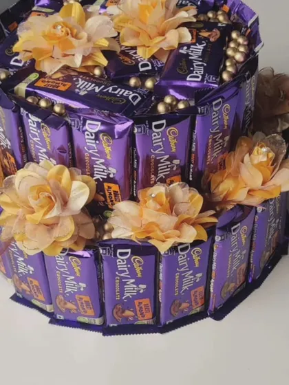 Another version of my two-tier Dairy Milk chocolate cake, this one decorated with beautiful yellow artificial flowers and gold bead detailing.