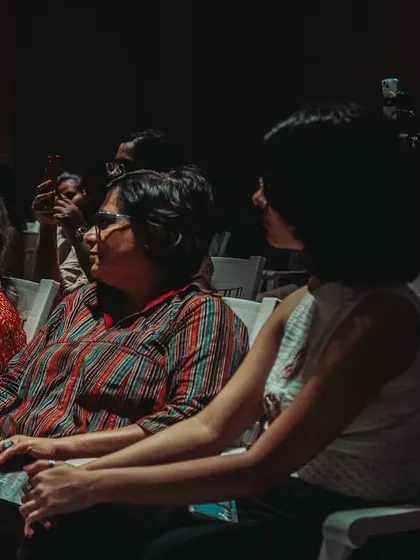 An engaged audience listening intently during a talk, showcasing the focused atmosphere of our events.