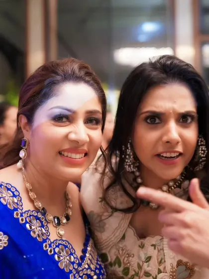 A funny, candid interaction between two guests at a party. These are the unposed moments that bring a wedding gallery to life.