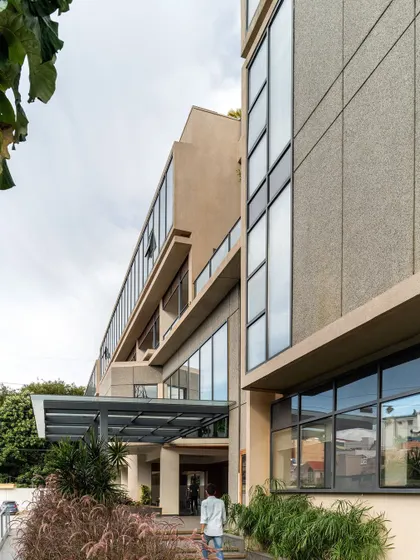 The entrance to the Koramangala Club Annexe. The design uses a simple and modern material palette to create a building that is contemporary yet respectful of the existing club structures on the campus.