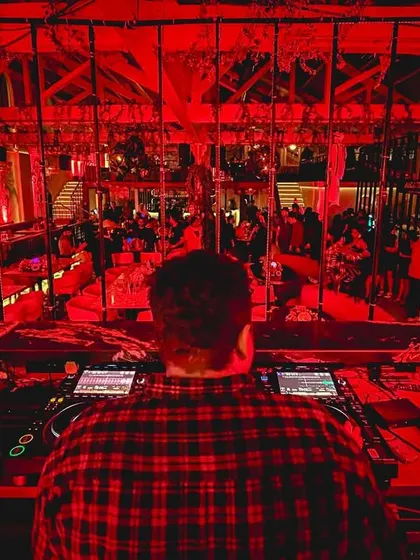 A view from behind the decks during a Halloween party. The red lighting created a spooky, high-energy atmosphere.