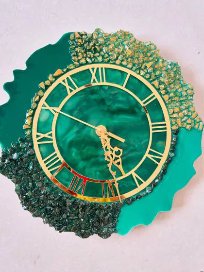 An irregular-shaped geode clock in a vibrant green, showcasing the unique and artistic designs that can be achieved with epoxy resin and stone embellishments.