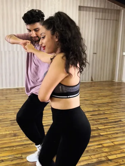 Executing a turn during a Bachata demonstration. Proper technique and a strong frame are essential for smooth and effortless looking partnerwork.