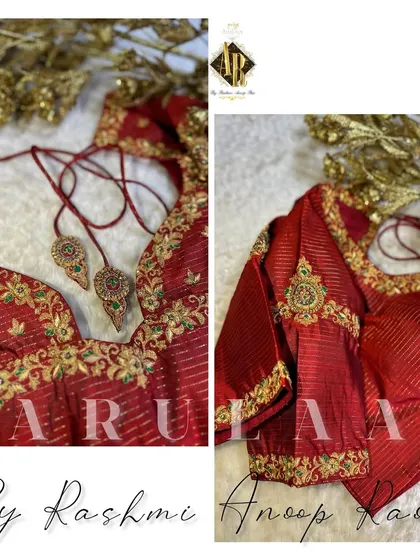 A beautiful red blouse with striped fabric, featuring a floral vine embroidery along the neckline and sleeve cuffs. The custom latkans are designed to match the kundan work on the blouse.