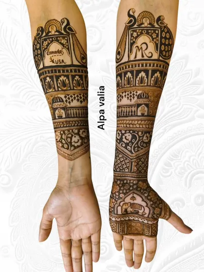A full view of the travel-themed bridal mehendi, showing both arms. One arm is personalized while the other maintains a classic, intricate design.