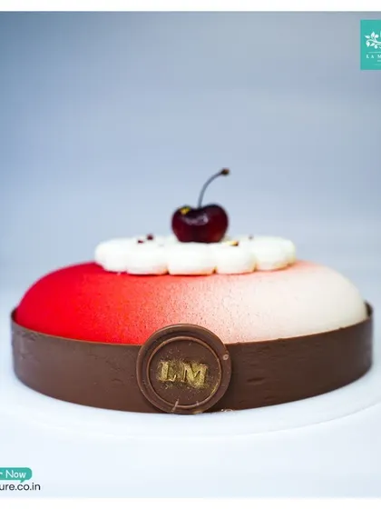 A side view of the Black Forest Revisited cake, highlighting the smooth gradient of the red and white velvet texture.