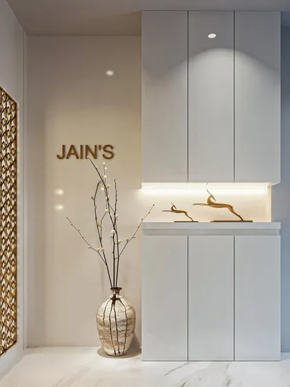 Everything seamless. This foyer design for the Jain family features clean lines, hidden storage, and a beautifully lit niche for decor, creating a welcoming and clutter-free first impression.