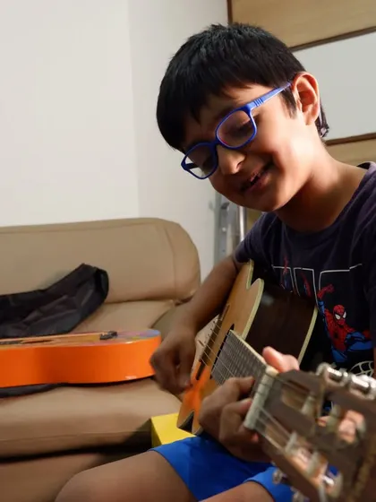 The smile of a young student who has just nailed a difficult chord. These small victories build great confidence.