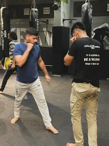Two students spar, practicing their boxing and defensive movements. This kind of live drilling is essential for learning timing, distance, and how to read an opponent.