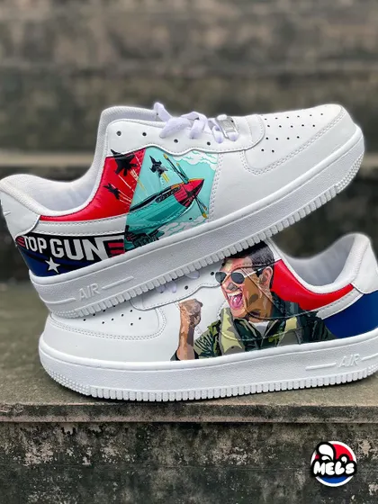 Feel the need for speed with these custom 'Top Gun' themed Nike Air Force 1s. We've got Maverick in his jet on one shoe and a portrait of Tom Cruise on the other, complete with the iconic movie logo. It's the ultimate wearable tribute for any fan of the film.