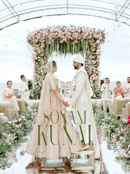 Against the serene backdrop of the Thailand coast, the couple shares a quiet moment under a magnificent floral mandap. This image captures the peaceful, romantic essence of a destination beach wedding.