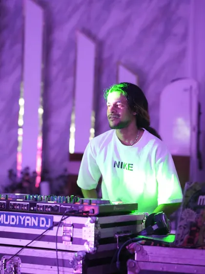 A candid shot of me at the decks during a wedding, with the venue's elegant decor and lighting in the background.