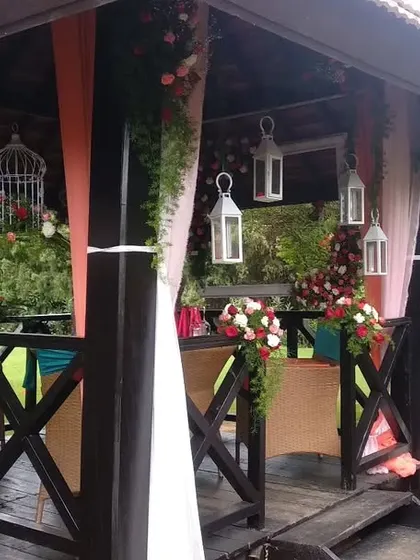 An intimate and romantic surprise birthday party in a beautiful outdoor gazebo. We used soft drapes, hanging lanterns, and floral arrangements to create a special atmosphere.