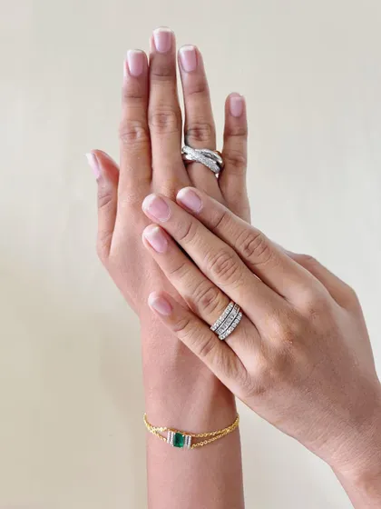 Where elegance is eternal and sparkle is endless. This image showcases a beautiful pairing of diamond rings and an emerald bracelet, a testament to timeless style.