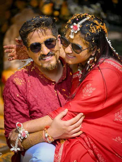 A happy couple portrait right after the Haldi rituals, covered in turmeric and love. Their smiles say it all.