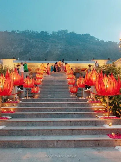 A close-up of the hand-fabricated red lotus lights that lined the bride's entrance path, each one carefully crafted and assembled by our team.