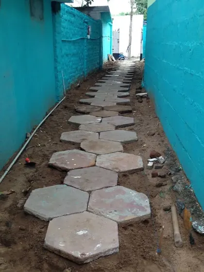 The pathway continues to take shape. This style of stone path is perfect for creating a rustic, natural feel in a garden.