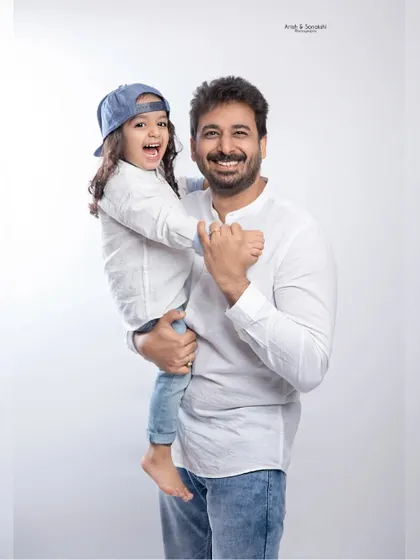 A proud dad with his happy daughter. We love capturing these heartwarming moments during our family studio sessions.