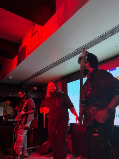 A candid shot of the band on stage at The Stables, bathed in red light. We adapt our energy and look to fit the vibe of any venue.