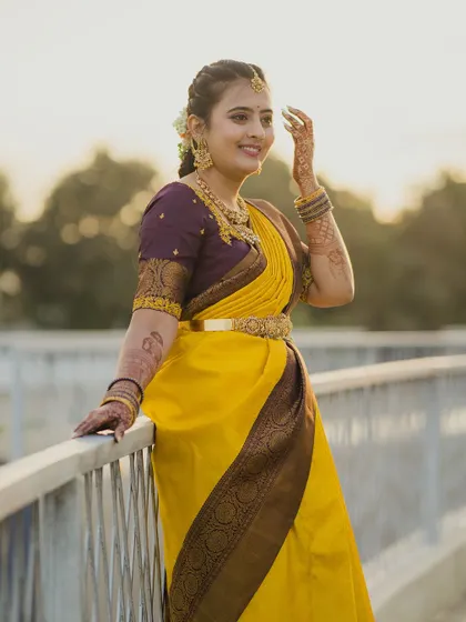 A beautiful bride in a yellow saree, captured in the warm light of the golden hour. We use natural settings to create portraits that feel both elegant and organic.